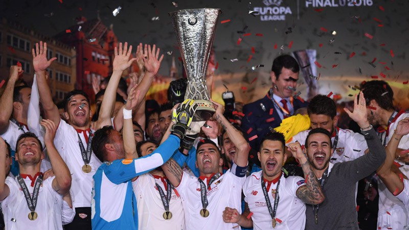 Sevilla players lift the cup